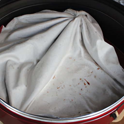 A Dutch oven being dried with a soft cloth after cleaning.